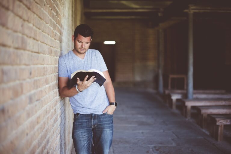 A Man Studying From A Book