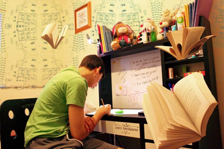 A Boy Studying In His Room